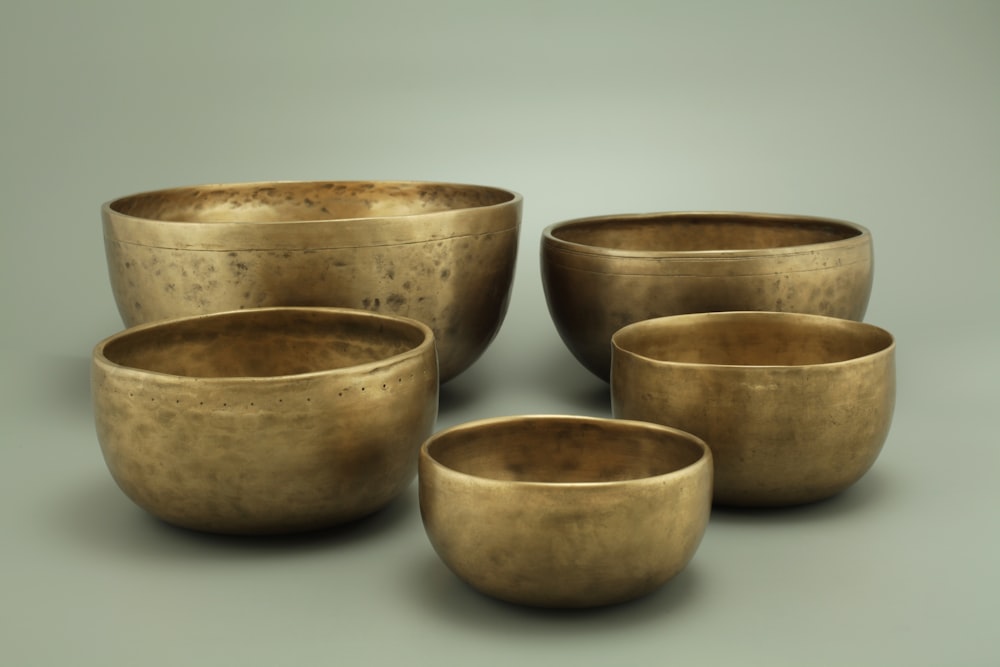 3 brown ceramic bowls on white surface