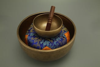 brown wooden mortar and pestle on blue and white floral ceramic bowl