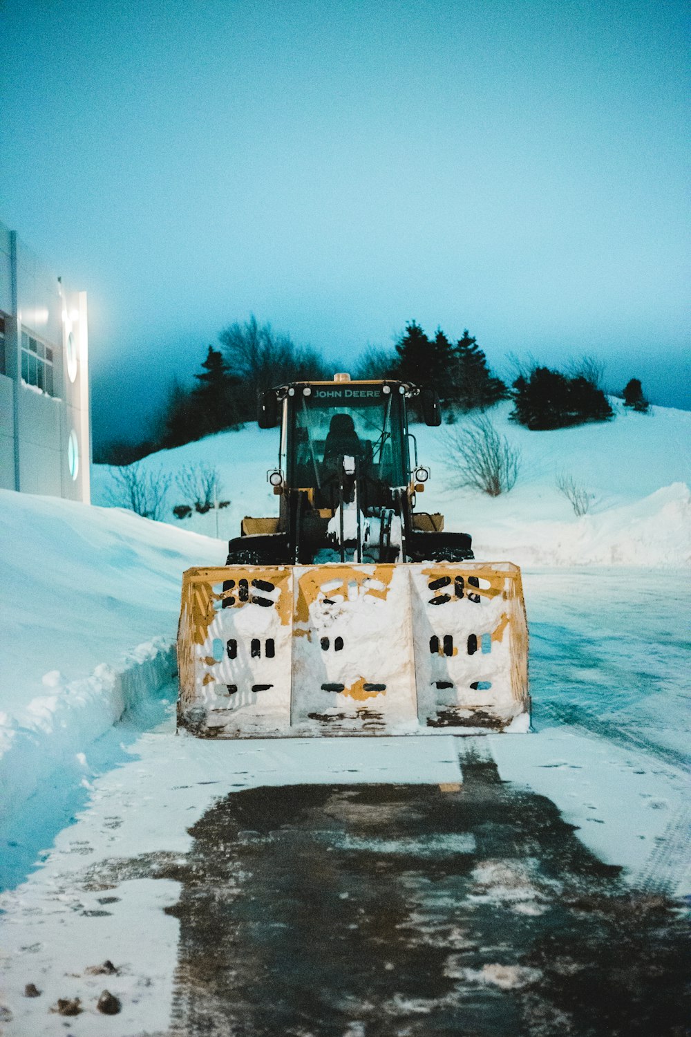 black and yellow heavy equipment on snow covered ground during daytime