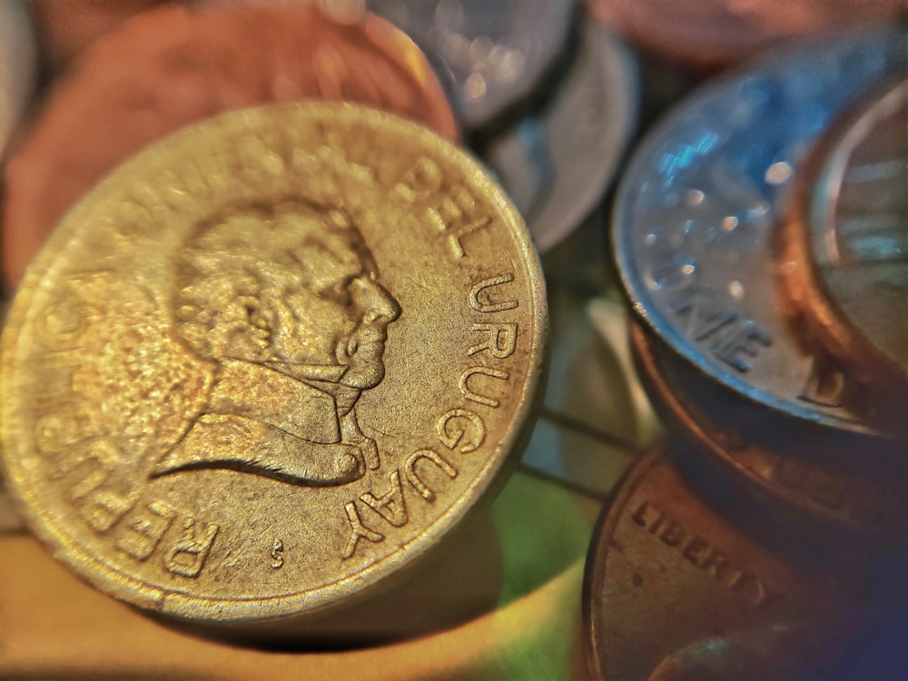 silver round coin on green surface