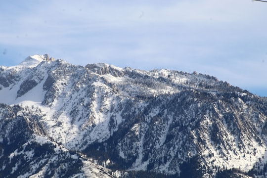 snow covered mountain under blue sky during daytime in Wasatch Mountains United States