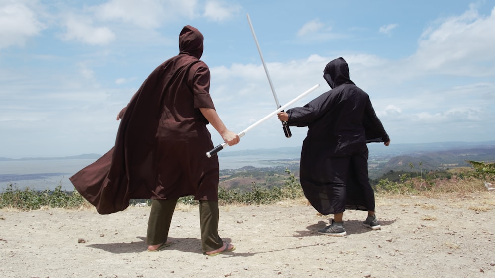 man in red hoodie holding white stick