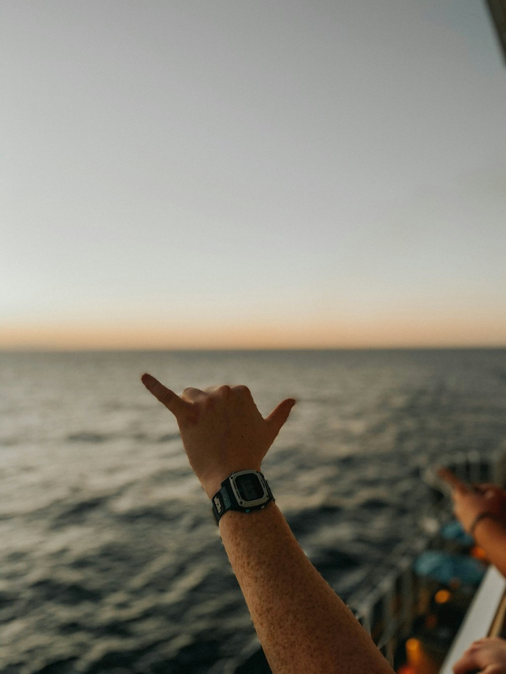 person wearing silver link bracelet watch