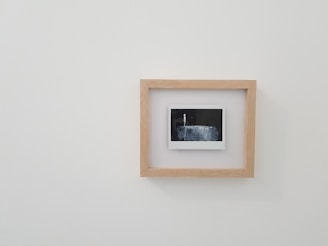 brown wooden framed photo on white wall