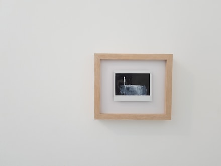 brown wooden framed photo on white wall