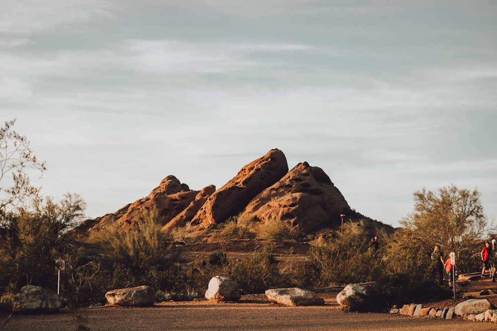 brown rock formation under white clouds during daytime