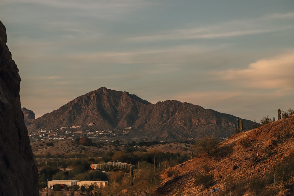 brown mountain under cloudy sky during daytime