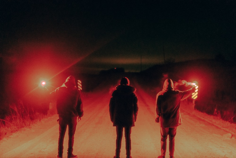 people standing on snow covered ground during night time