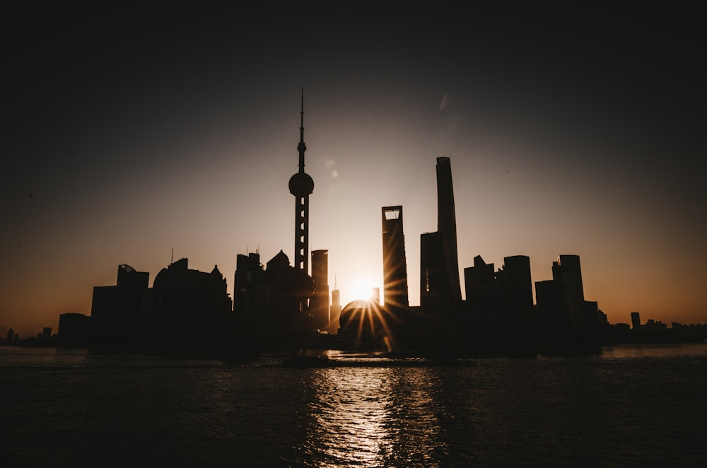 silhouette of city buildings during sunset