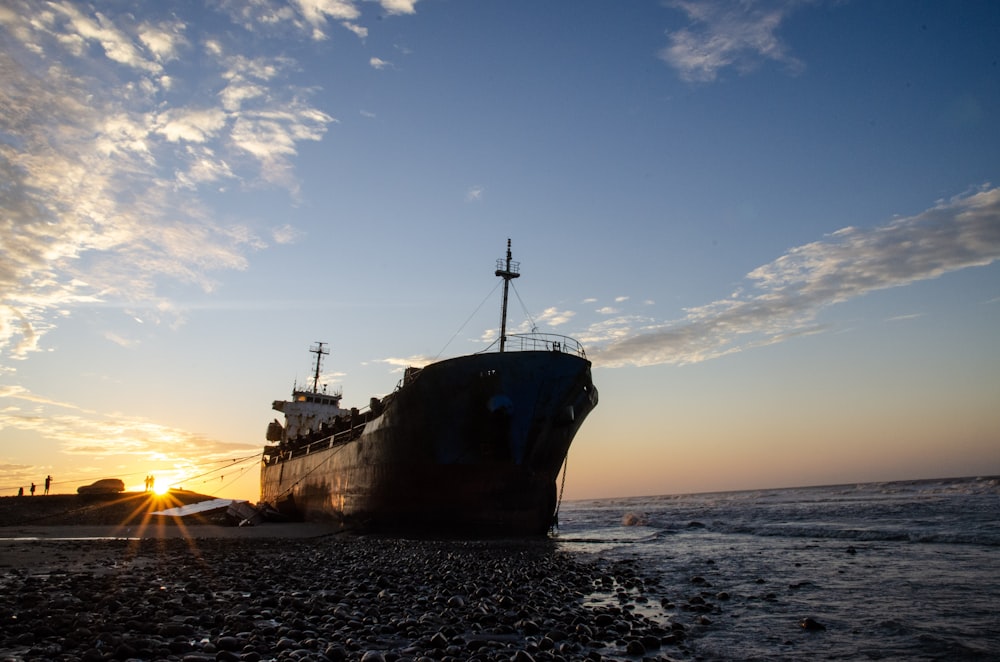 brown ship on sea under blue sky during daytime