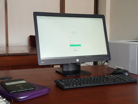 black computer monitor turned on beside black computer keyboard