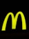 A bright yellow, large and bold 'M' shape against a stark black background, symbolizing a well-known fast-food brand.
