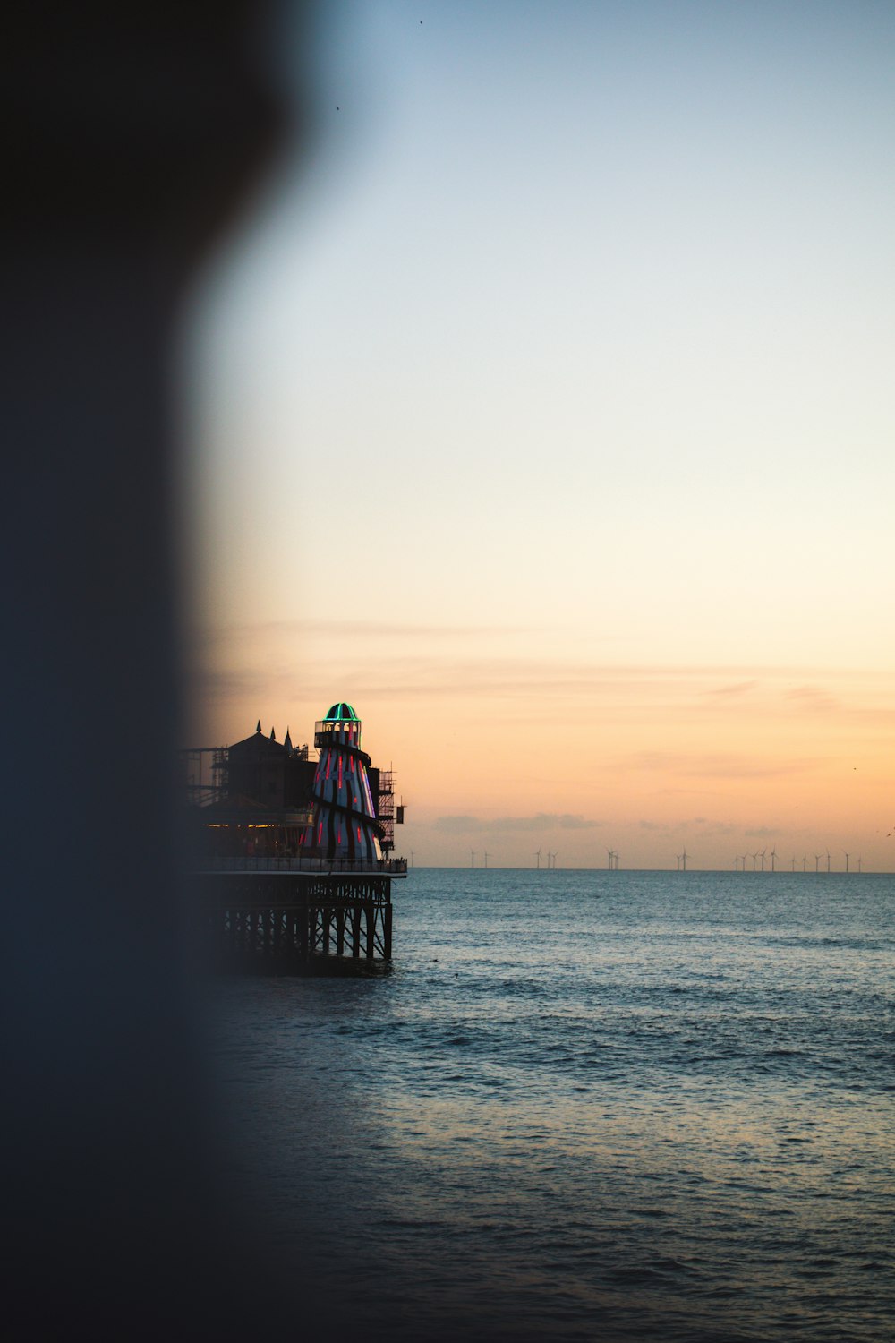 silhouette of people on dock during sunset