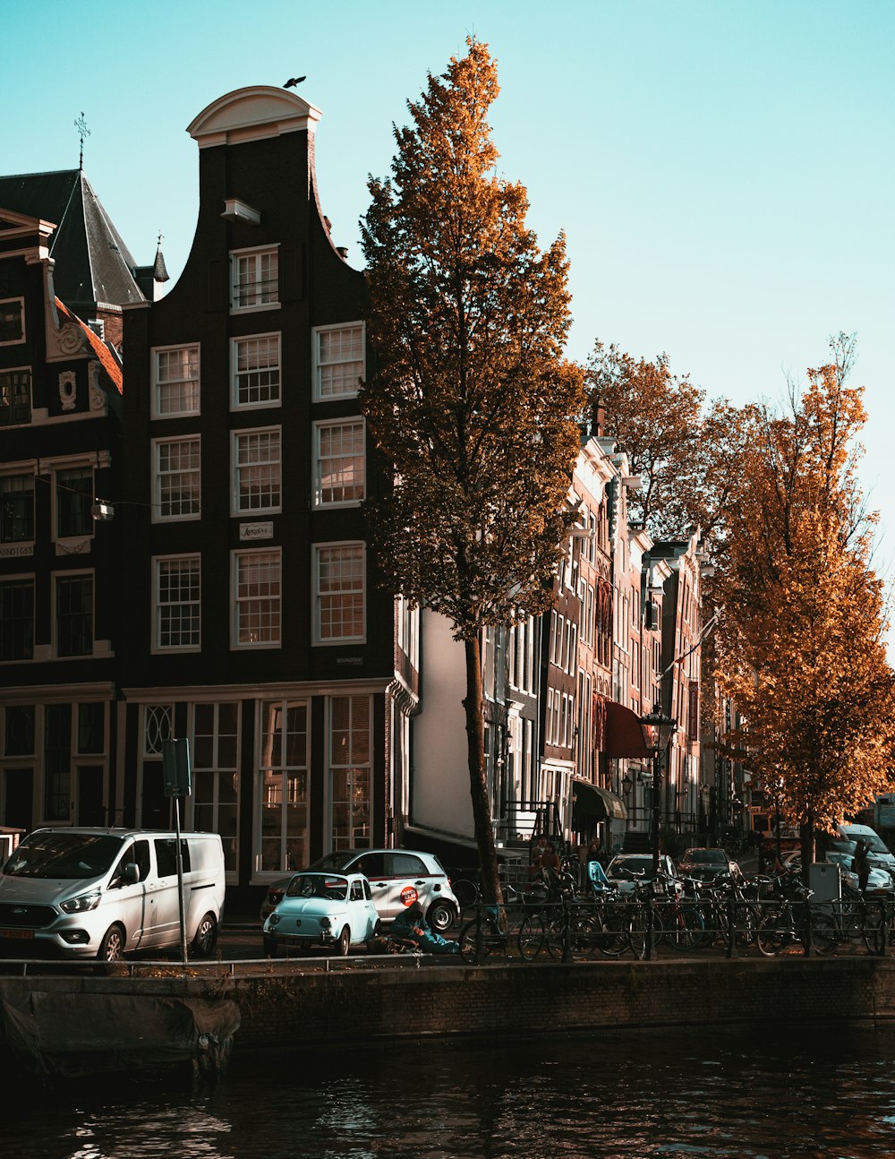 cars parked beside brown building during daytime