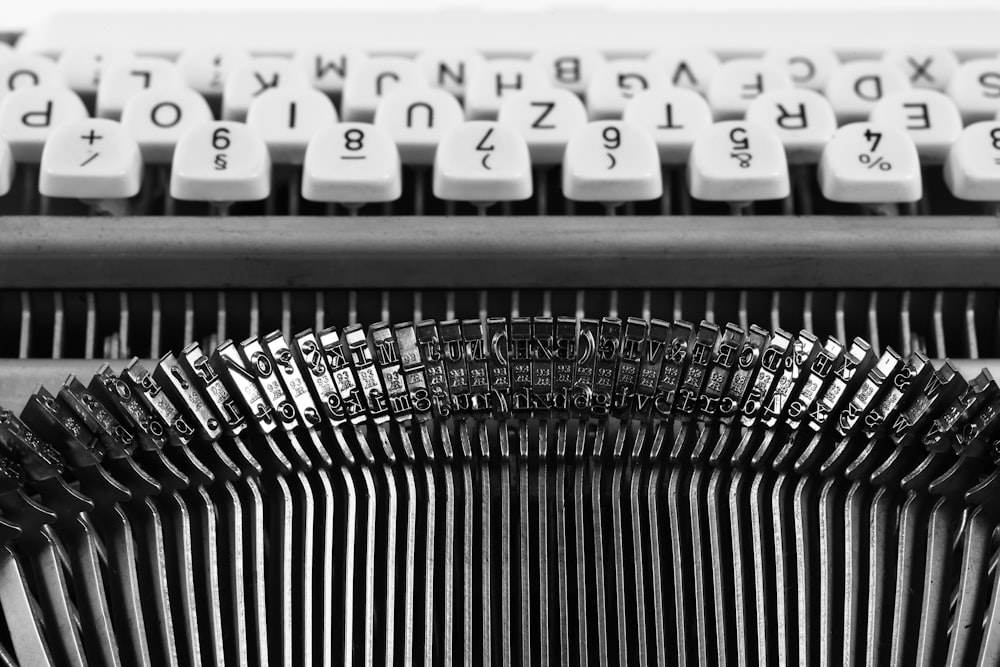 white and black typewriter on white table