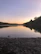 A peaceful lakeside view at sunset, inviting calm and reflection.