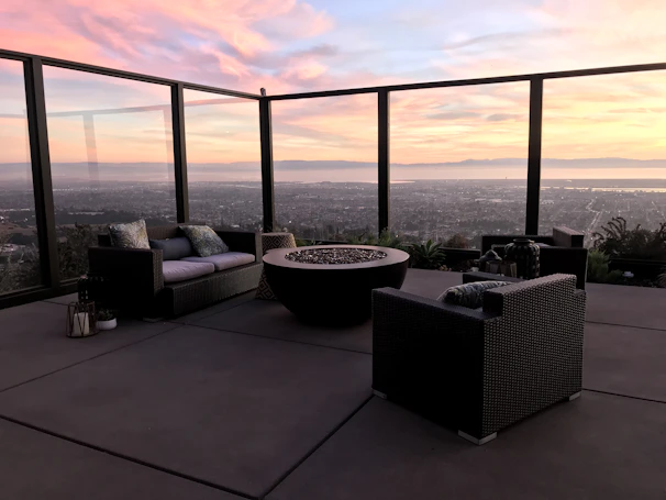 Luxurious outdoor living space featuring a stone fireplace and comfortable seating at a Hillcrest Luxe property