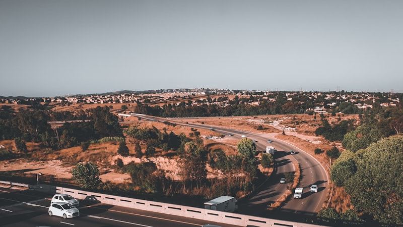 Aerial view of a South African highway with vehicles and surrounding town