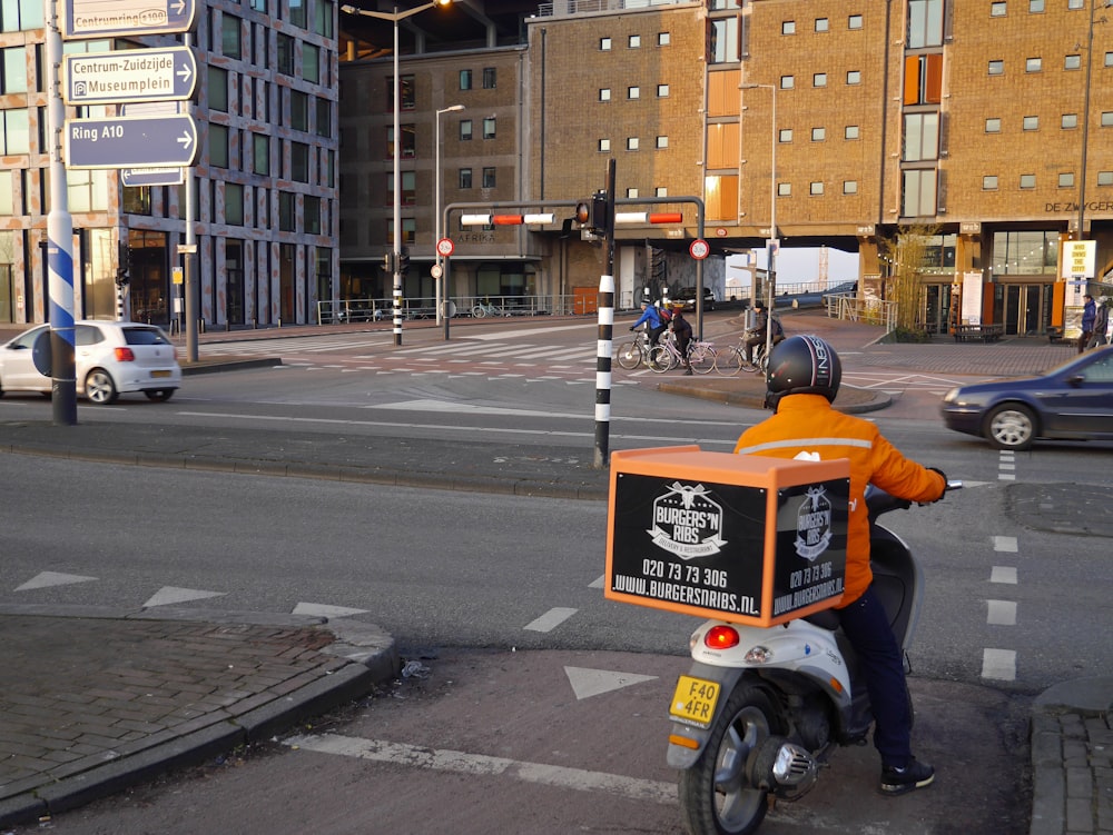 white and orange motorcycle on road during daytime