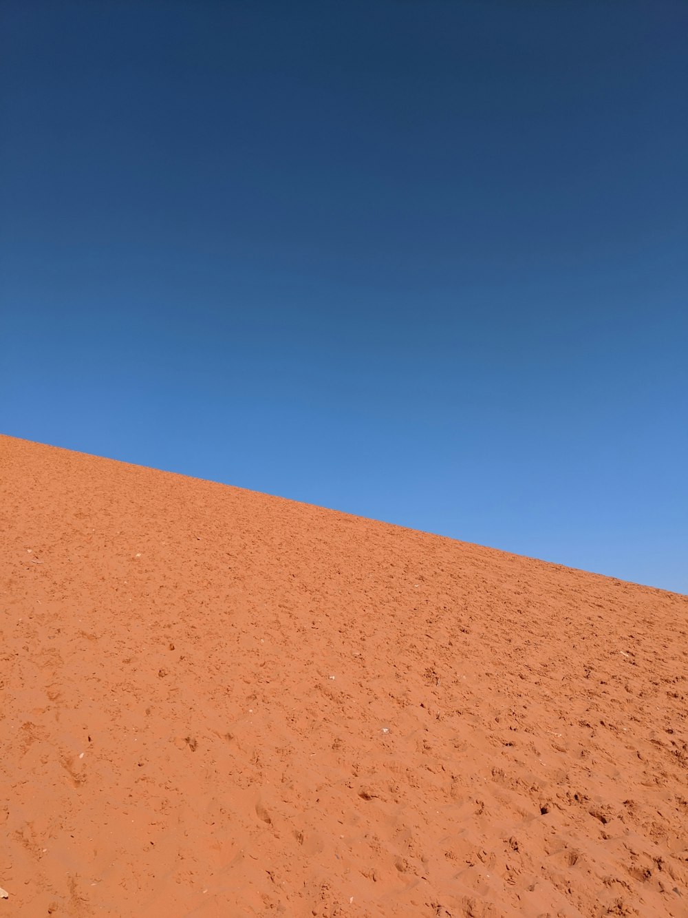 brown sand under blue sky during daytime