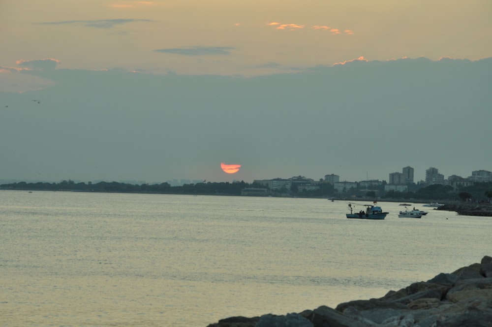 boat on sea during sunset