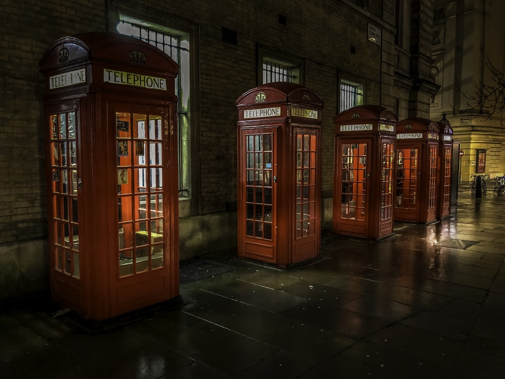 red telephone booth on brown brick floor