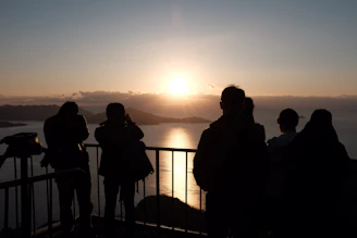 A serene outdoor scene showing a group of seniors gently performing tai chi at dawn.