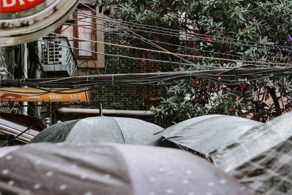 Narrow shikumen lane in Tianzifang Shanghai with old brick walls and hanging laundry
