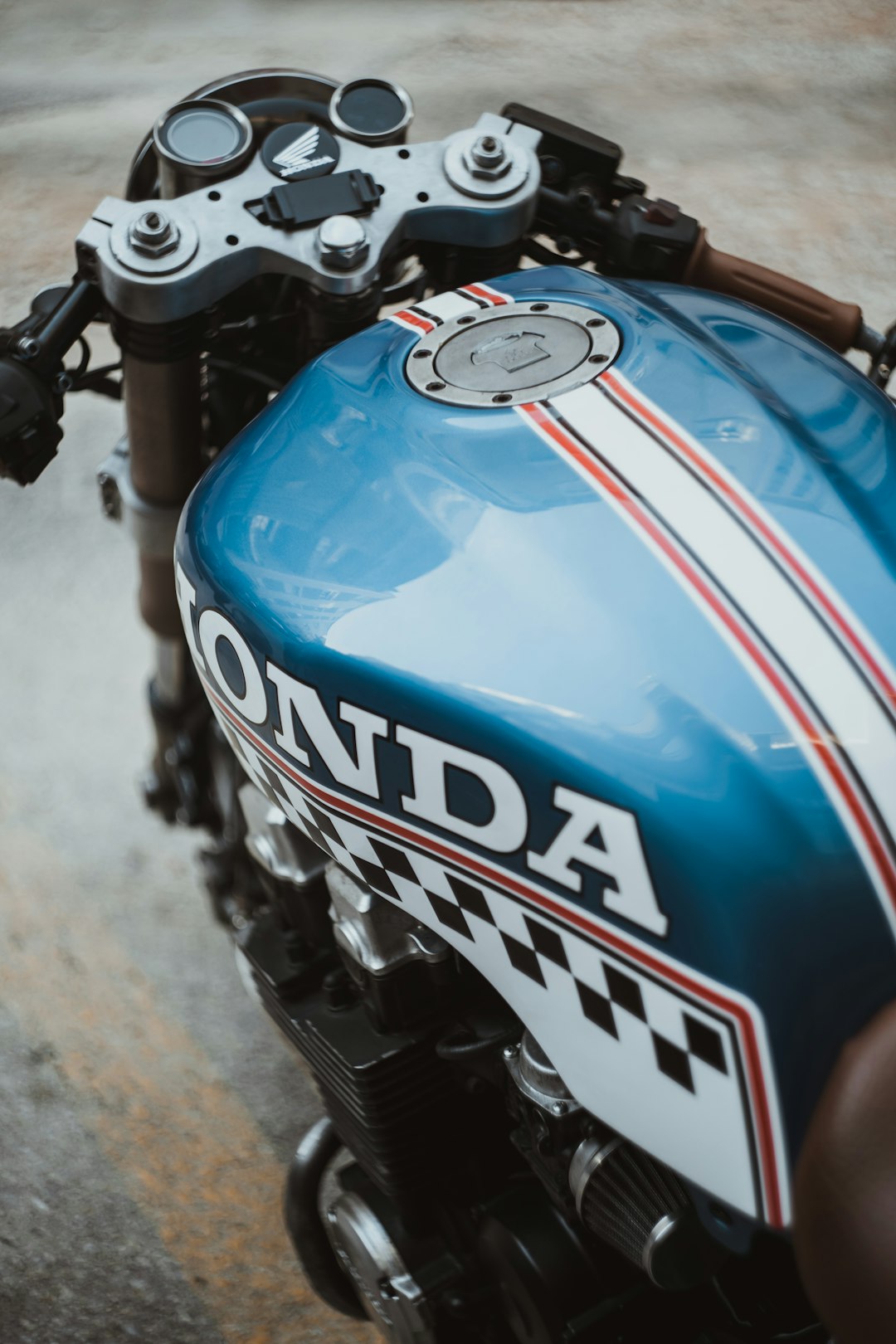 blue and black motorcycle on gray concrete road