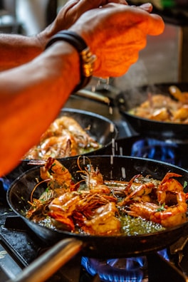 person holding stainless steel tray with cooked food