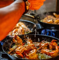 person holding stainless steel tray with cooked food