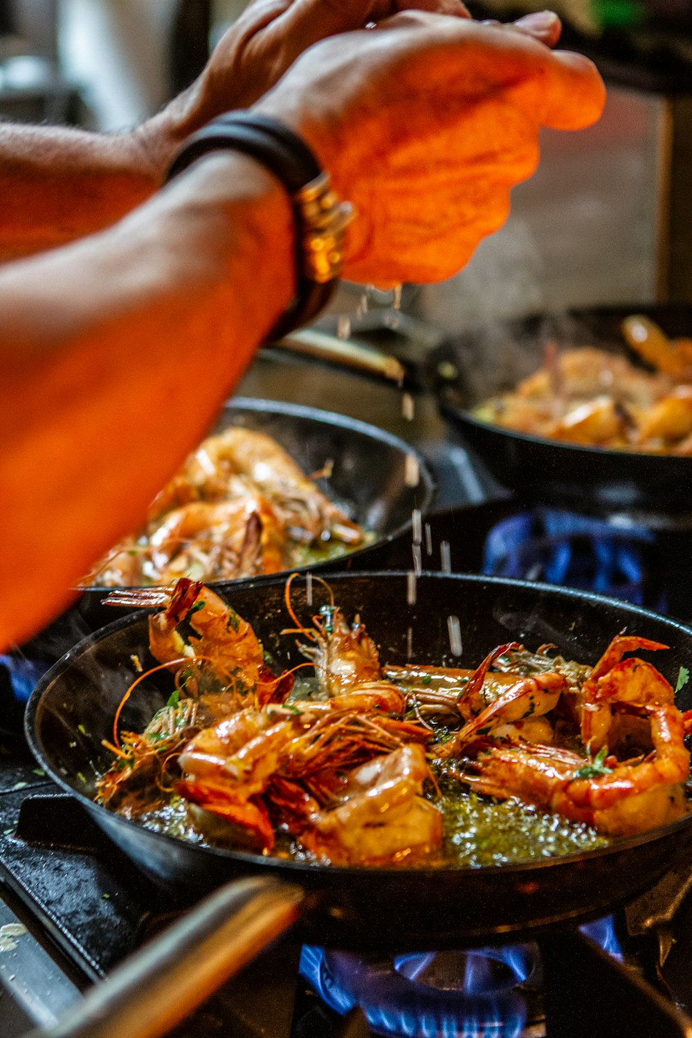 person holding stainless steel tray with cooked food