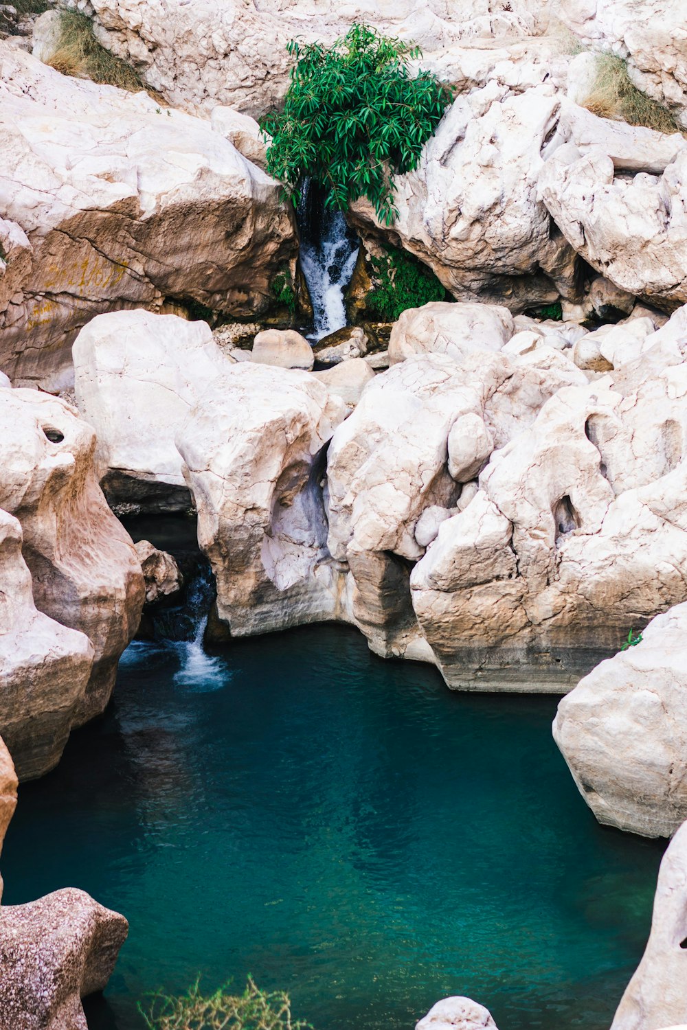 brown rock formation beside body of water during daytime