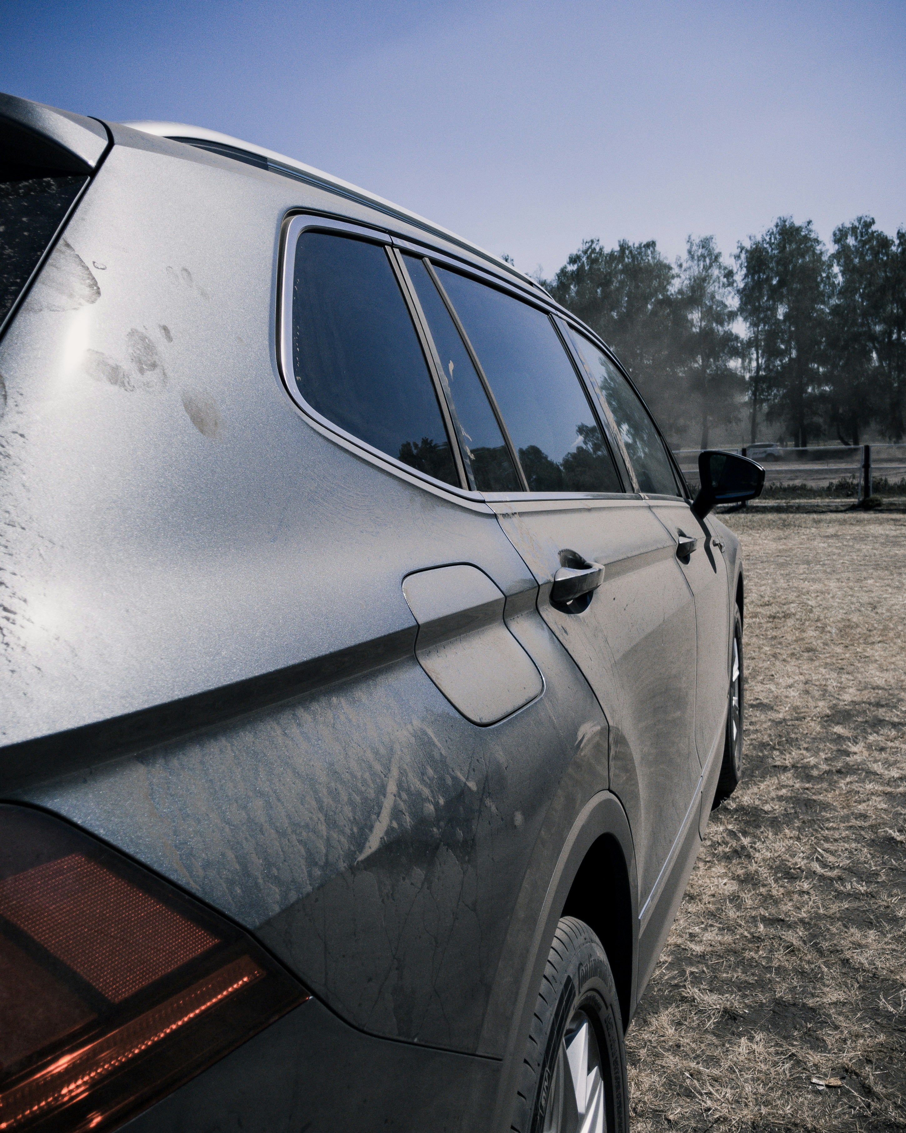 Dusty grey SUV before detailing, overcast daylight, visible dirt on bodywork