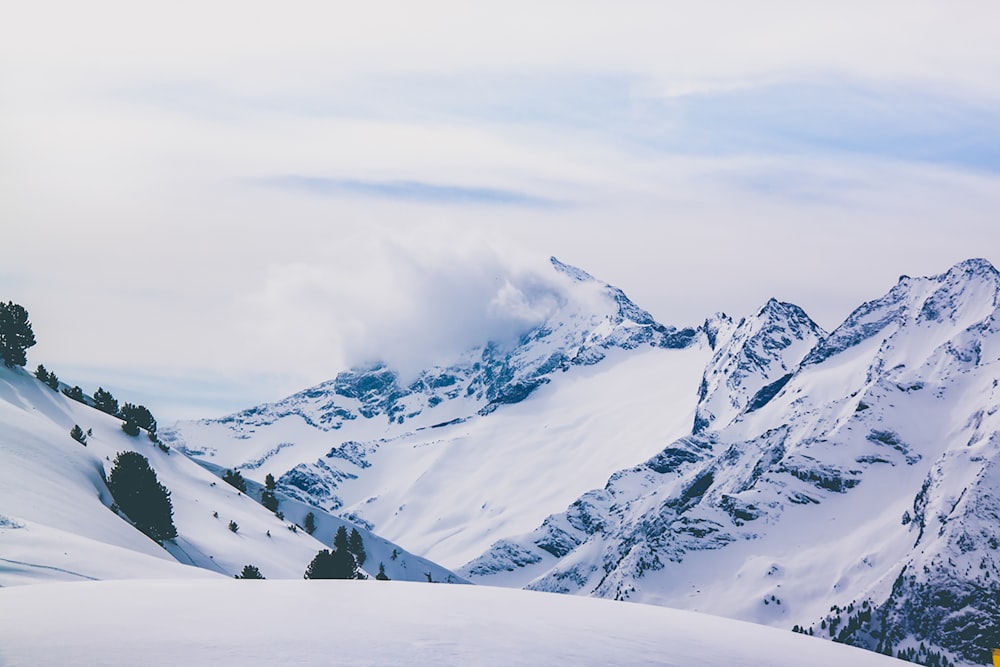 snow covered mountain under cloudy sky during daytime