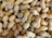 A large pile of unshelled peanuts with textured, tan-colored shells piled closely together, creating a natural and rustic appearance.