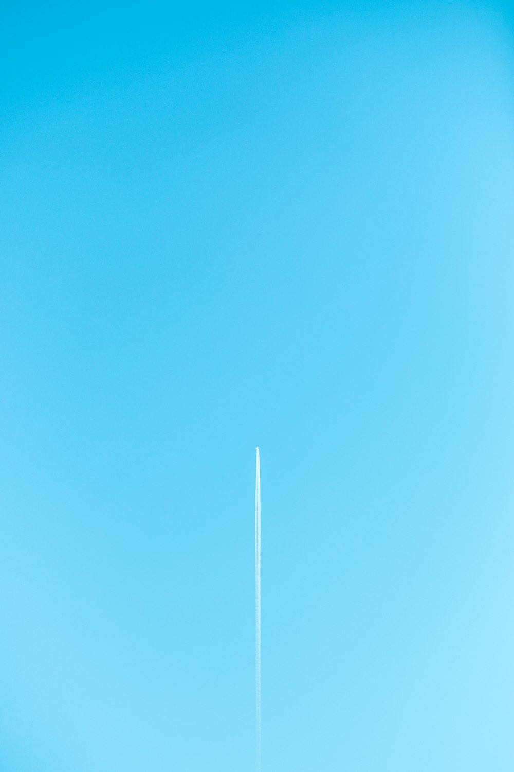 white plane on blue sky during daytime