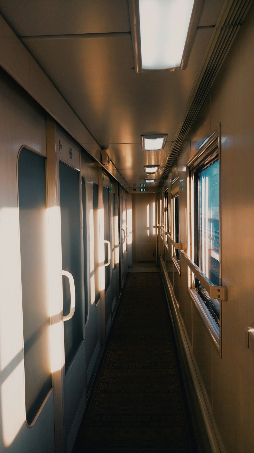 white and brown hallway with white ceiling