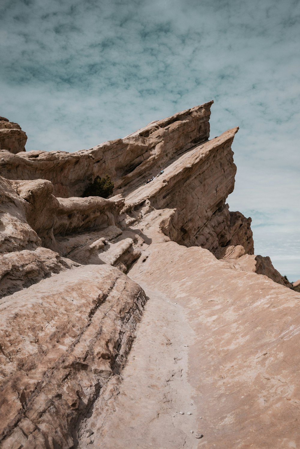 brown rock formation near body of water during daytime