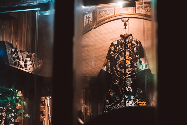 Close-up of a richly embroidered priest's robe in white and gold hues