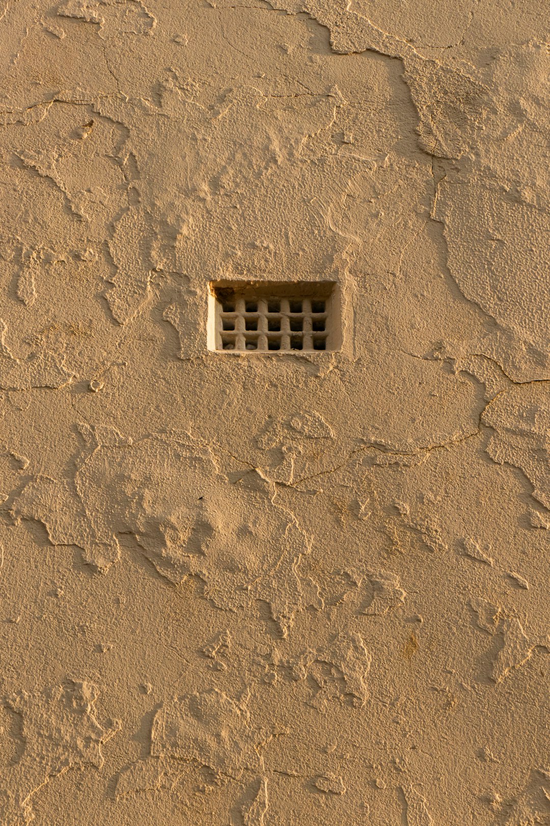 white concrete building on brown sand