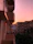 A cozy modern apartment balcony overlooking the sunset on the beach.