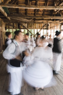 A group of people engaged in an expressive Aihondo dance session in a sunlit studio.