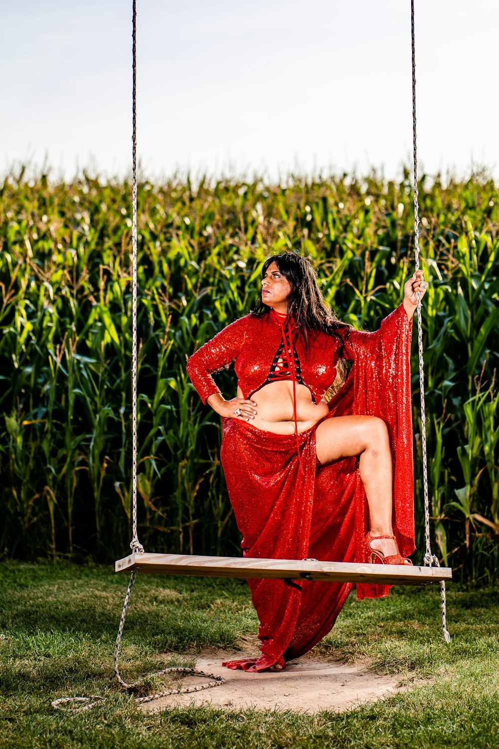 woman in red dress sitting on red hammock