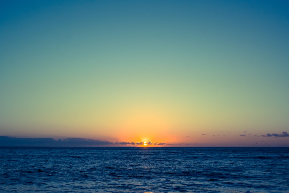 body of water during sunset