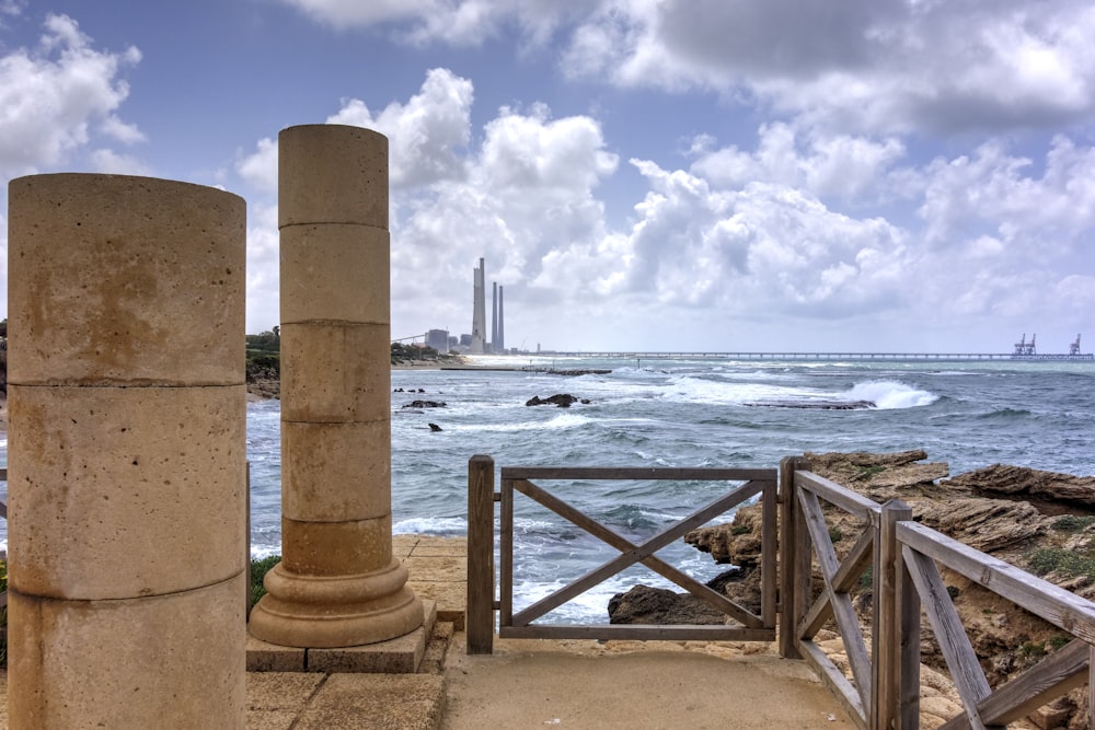 brown wooden dock on sea under white clouds during daytime