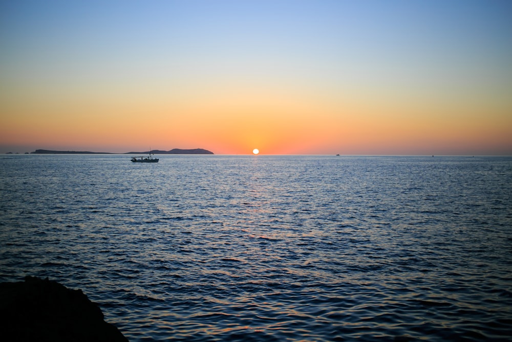 body of water during sunset