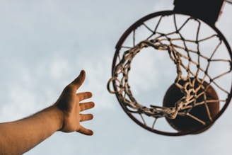 Photo of players aiming at vertical hoops during a xutbol match.