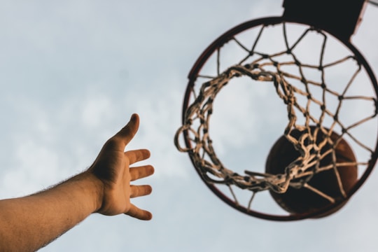 Photo of players aiming at vertical hoops during a xutbol match.
