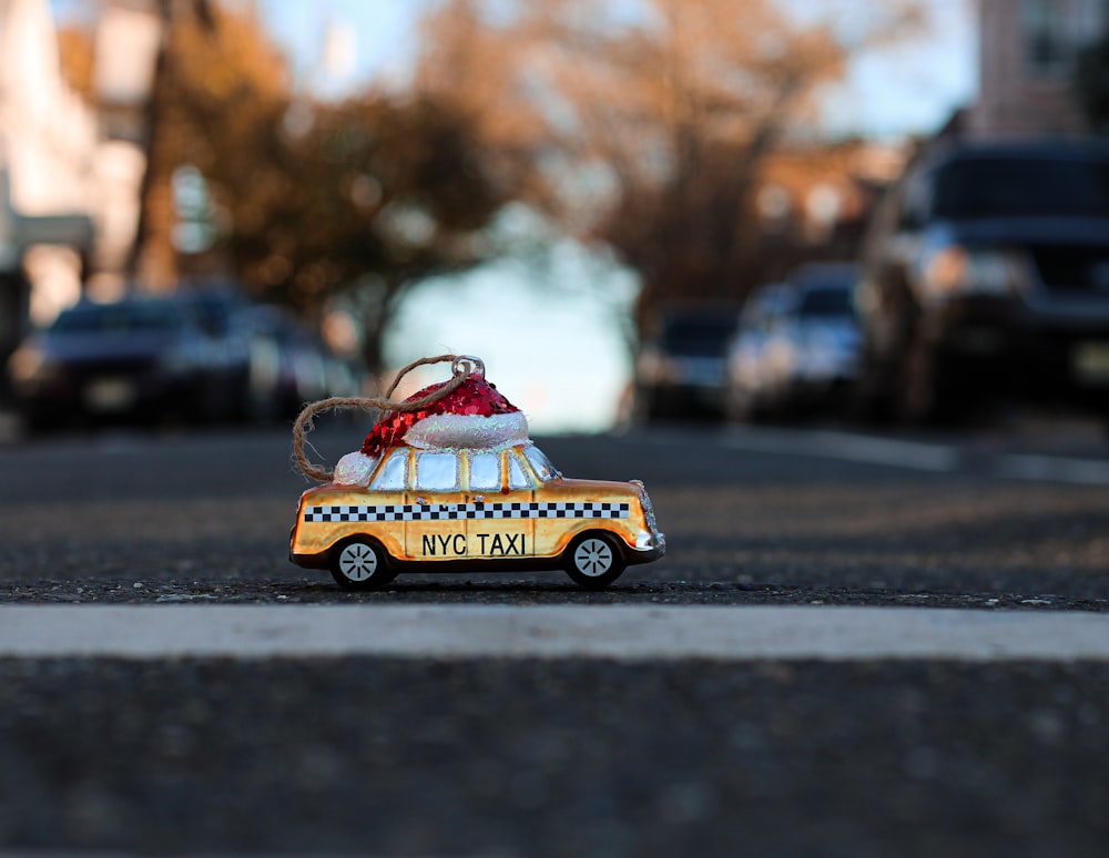 yellow and red car toy on road during daytime